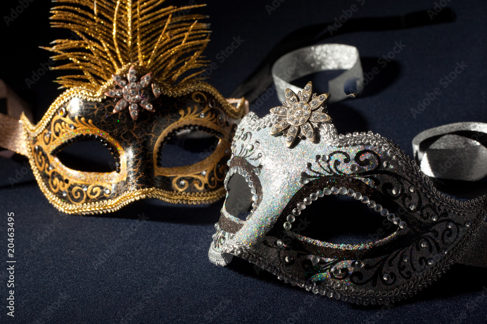 silver and black carnival masks isolated on a black background