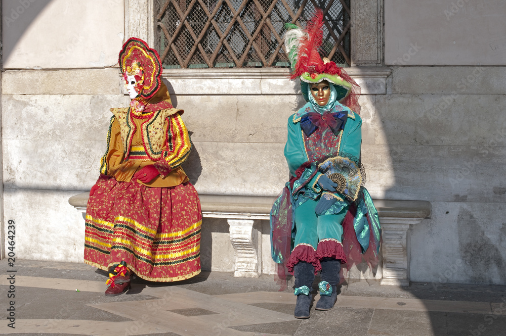 Carnival in Venice, disguised girls seated under the porch