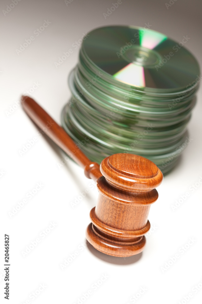 Stack of CD Rom or DVD Discs and Gavel Stack of CD Rom or DVD Discs and Gavel