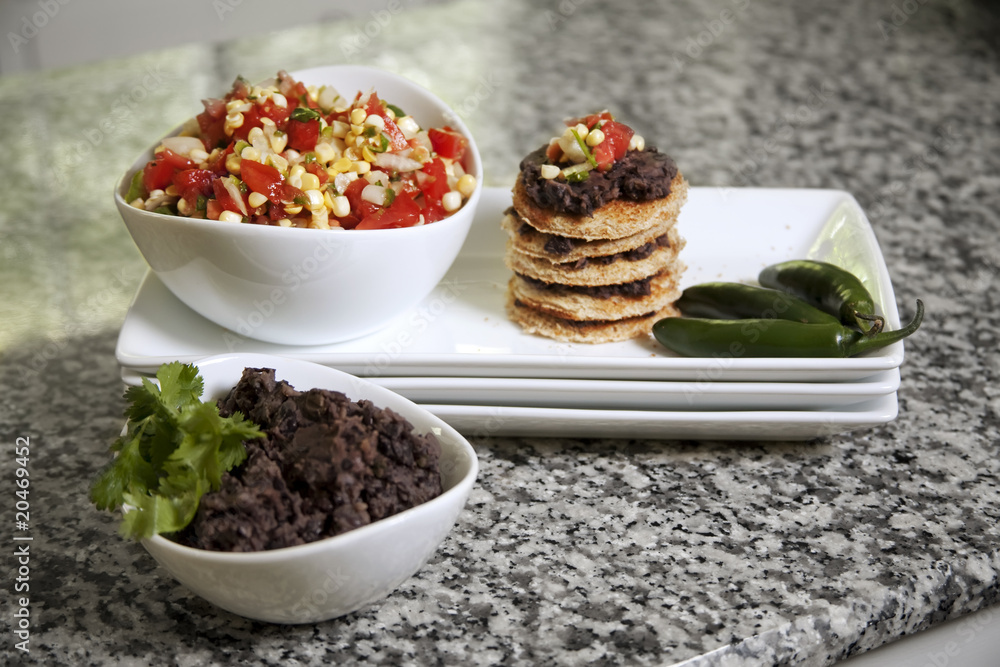Corn salsa, black bean dip served on a stack of toasted bread Corn salsa, black bean dip served on a stack of toasted bread