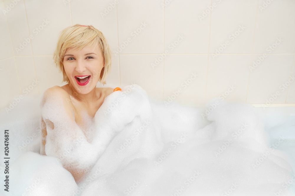 woman lying in bubble bath . woman lying in bubble bath .