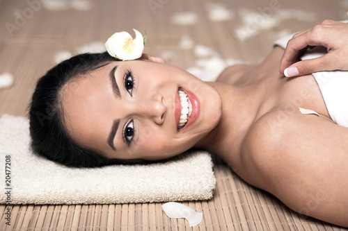 bautiful smiling woman lying down for spa treatment