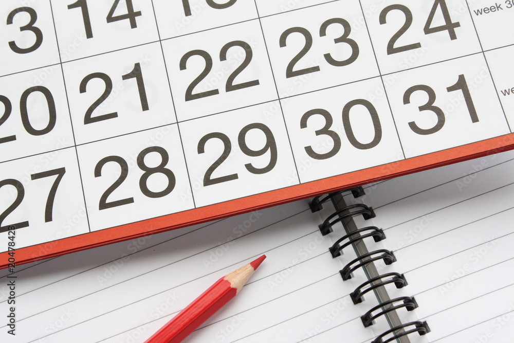 Calendar and notebook with pencil