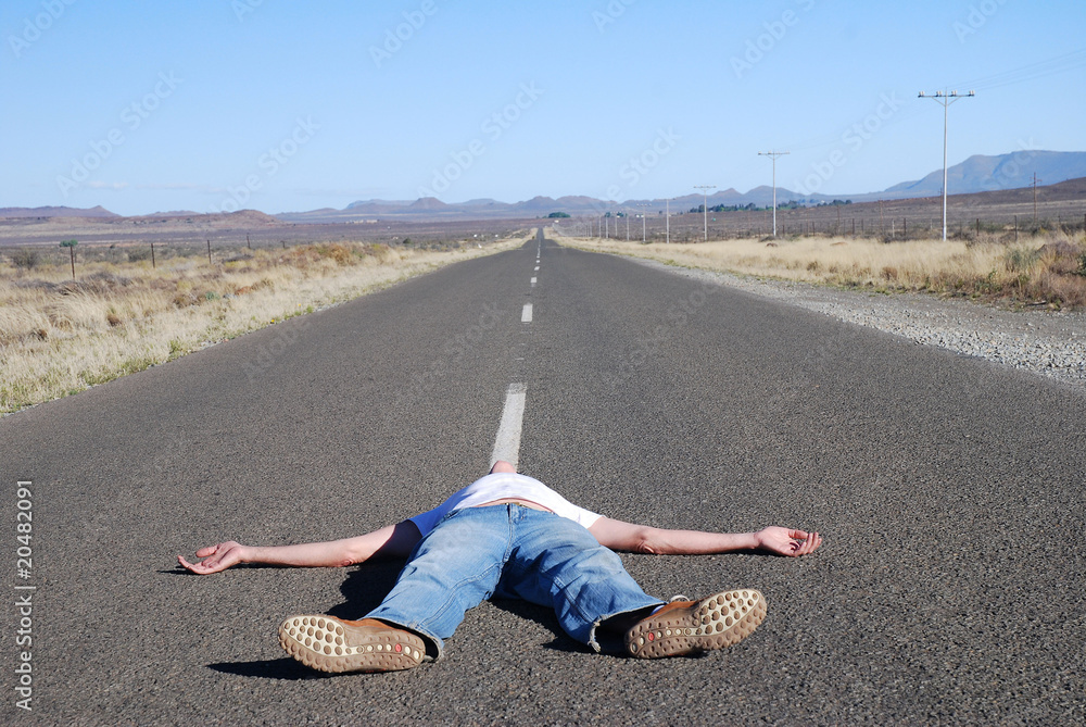 Obraz premium Man lying in the road