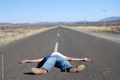 Man lying in the road photo