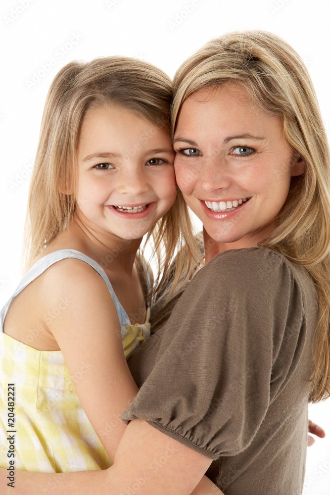 Studio Portrait Of Mother Hugging Young Daughter Studio Portrait Of Mother Hugging Young Daughter