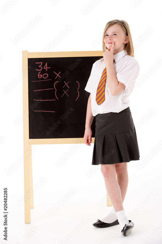 Thoughtful Female Student Wearing Uniform Next To Blackboard Thoughtful Female Student Wearing Uniform Next To Blackboard