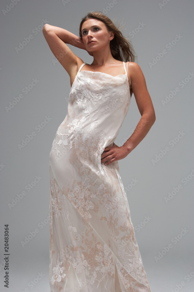 Fototapeta premium Full Length Studio Shot Of Young Woman In White Evening Dress