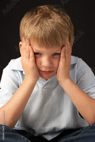 Studio Portrait Of Worried Boy