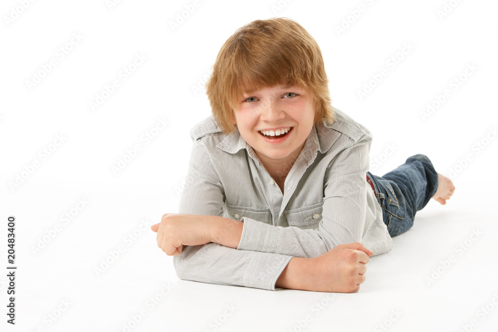 Young Boy Lying On Stomach In Studio Young Boy Lying On Stomach In Studio