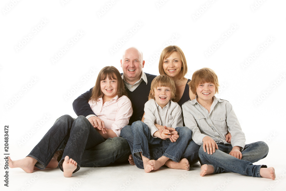 Studio Shot Of Family Group Sitting In Studio Studio Shot Of Family Group Sitting In Studio