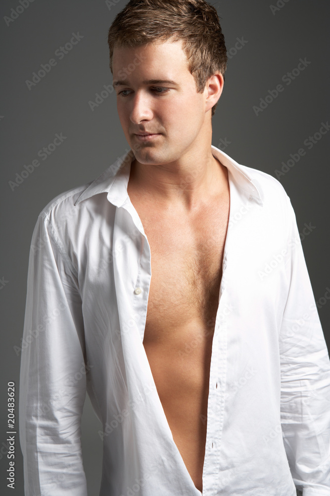 Studio Portrait Of Young Man Wearing Open Shirt Studio Portrait Of Young Man Wearing Open Shirt
