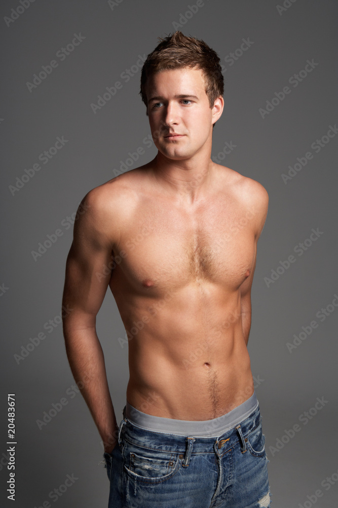 Studio Portrait Of Bare Chested Muscular Young Man Studio Portrait Of Bare Chested Muscular Young Man