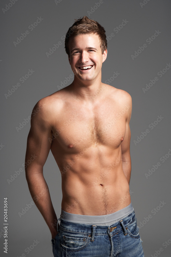 Studio Portrait Of Bare Chested Muscular Young Man Studio Portrait Of Bare Chested Muscular Young Man