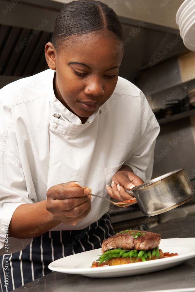 Chef Adding Sauce To Dish In Restaurant Kitchen Chef Adding Sauce To Dish In Restaurant Kitchen