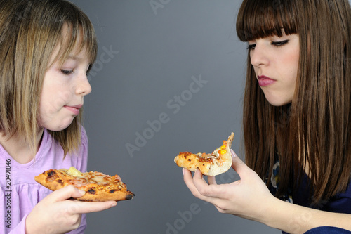 two caucasian teens evaluating fast food photo