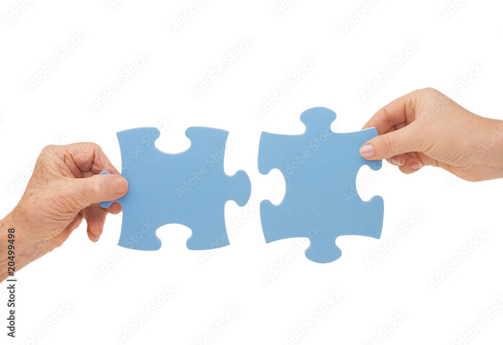 Hands and puzzle, isolated on white background Hands and puzzle, isolated on white background