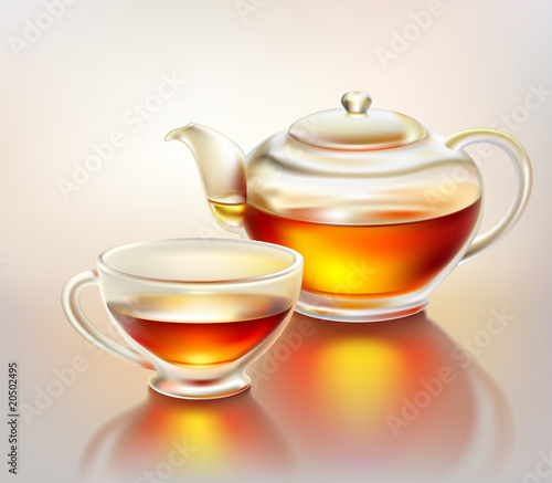 Glass teapot and cup with tea