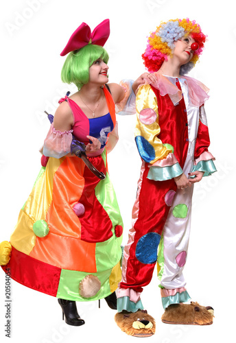 Two clown-girls in wigs and fancy costumes