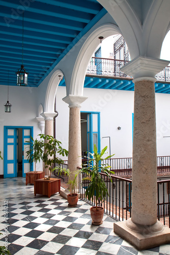 A view of colonial building interior with tropical flowers photo