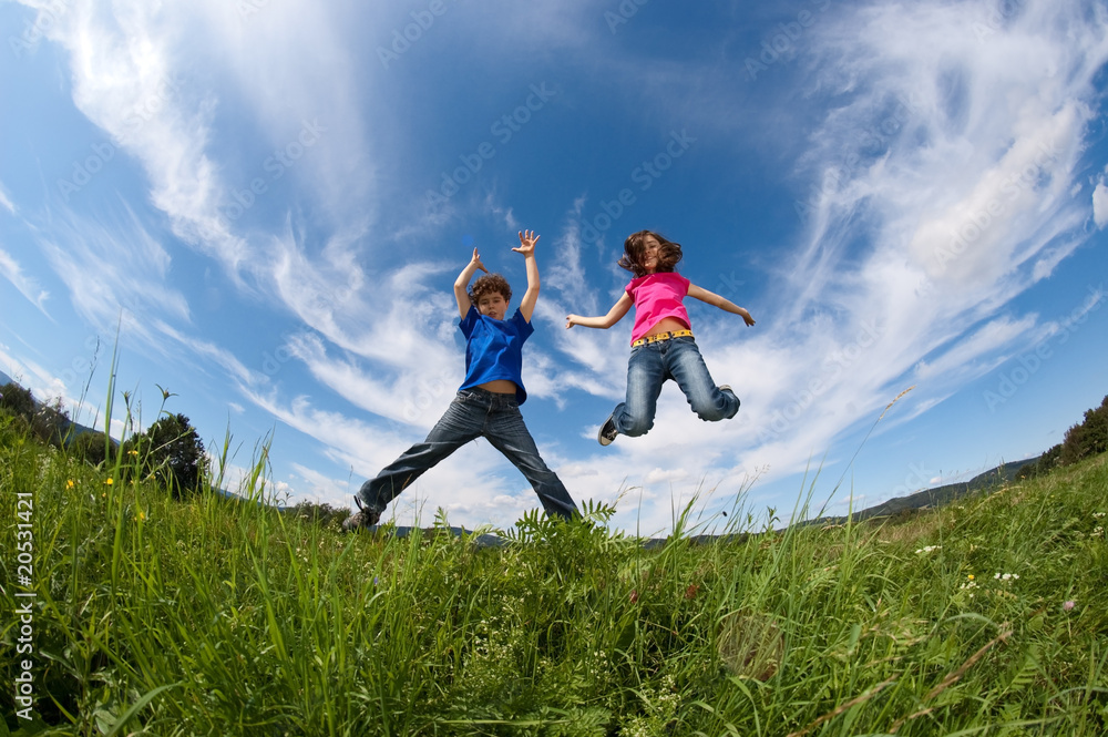 Kids jumping, running against blue sky Kids jumping, running against blue sky