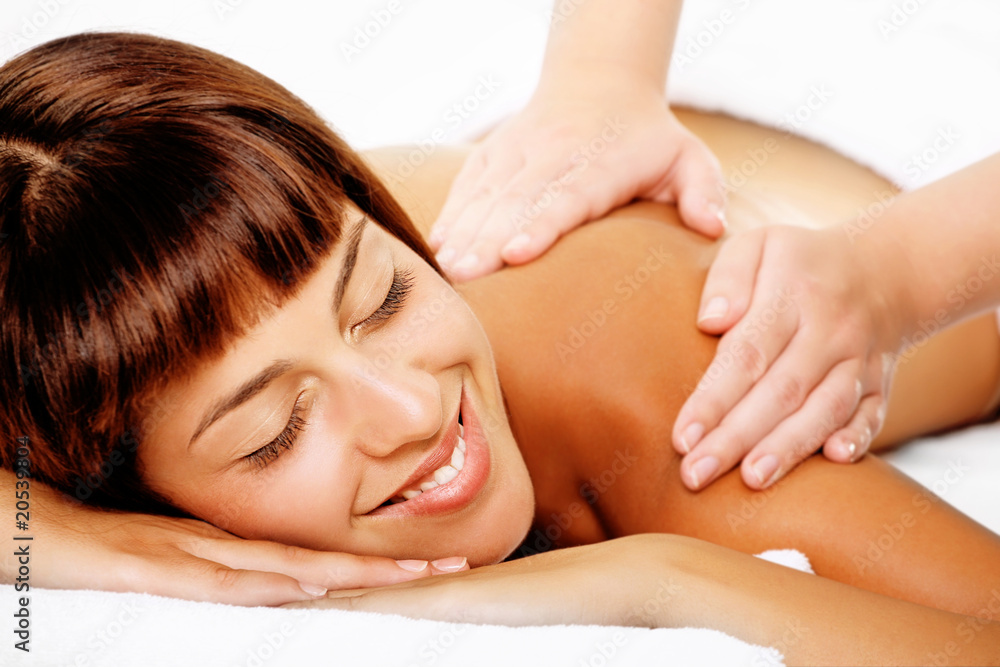 Close-up of a beautiful smiling woman getting a massage. Close-up of a beautiful smiling woman getting a massage.