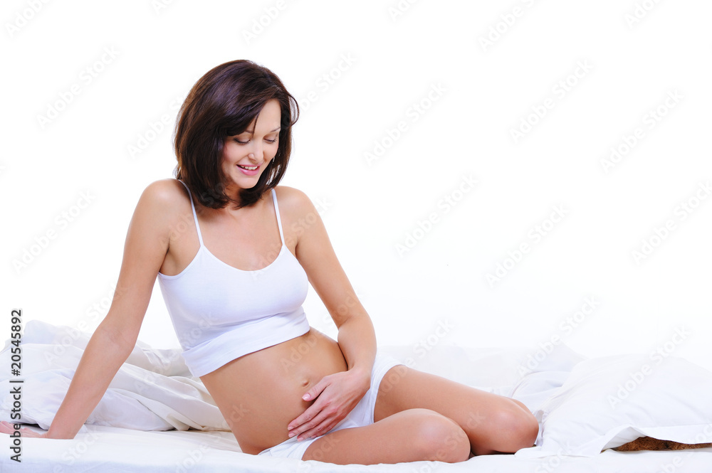 Pregnant woman stroking her tummy Pregnant woman stroking her tummy
