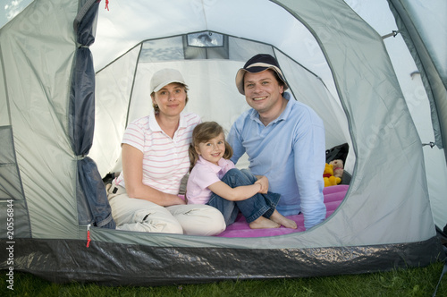 Happy family camping in tent