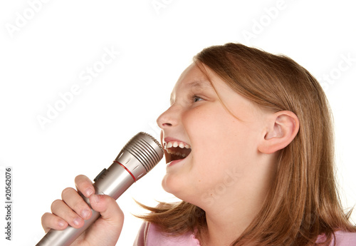 young girl singing karaoke on white