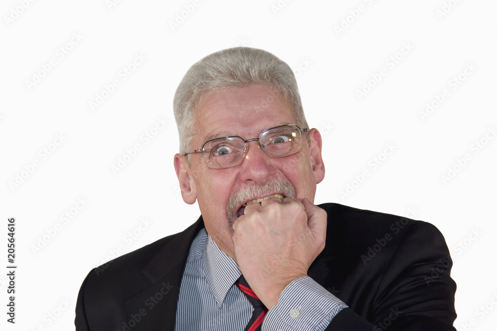 caucasian senior manager biting into his fist caucasian senior manager biting into his fist