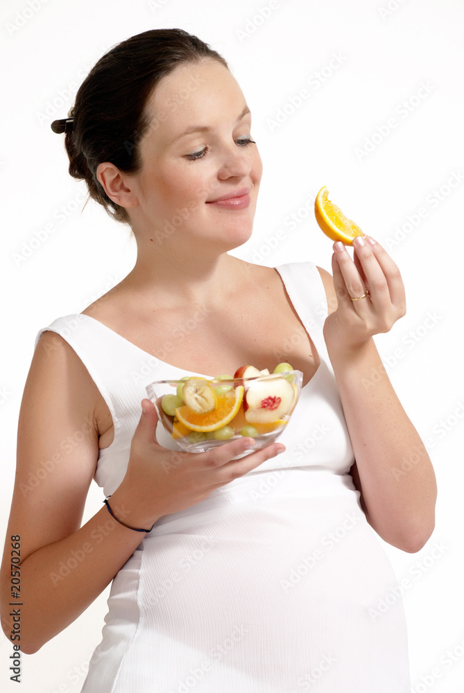 The pregnant woman with fruit on a light background The pregnant woman with fruit on a light background