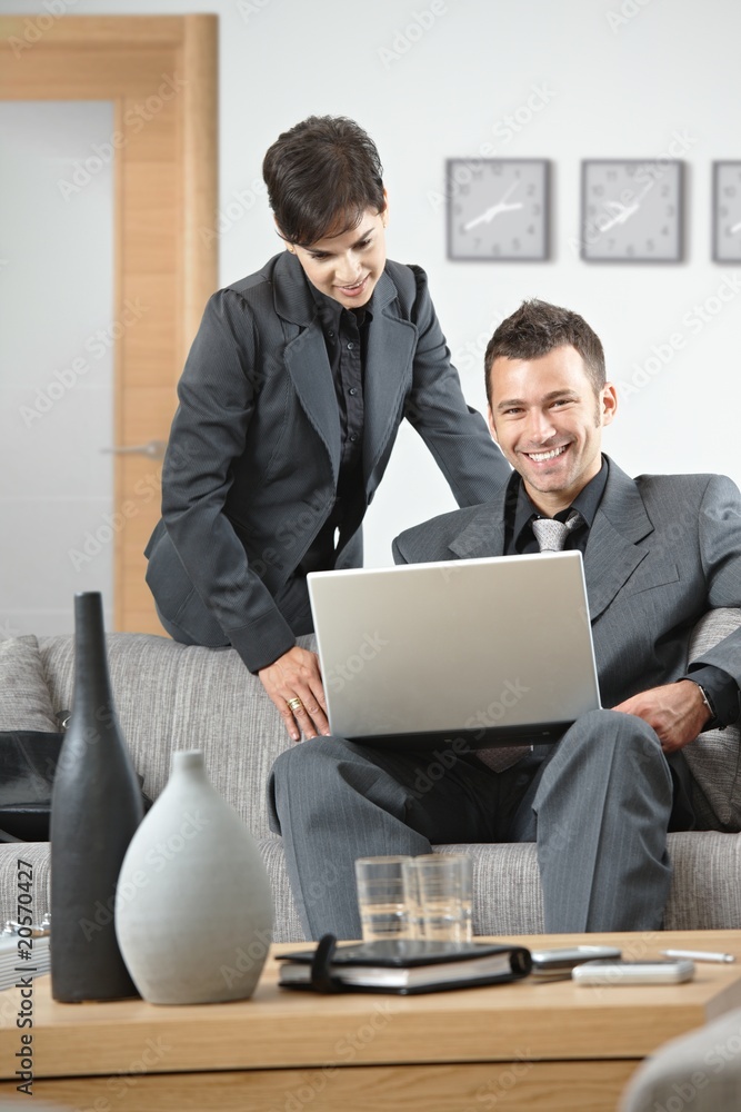 Happy businesspeople working at office Happy businesspeople working at office