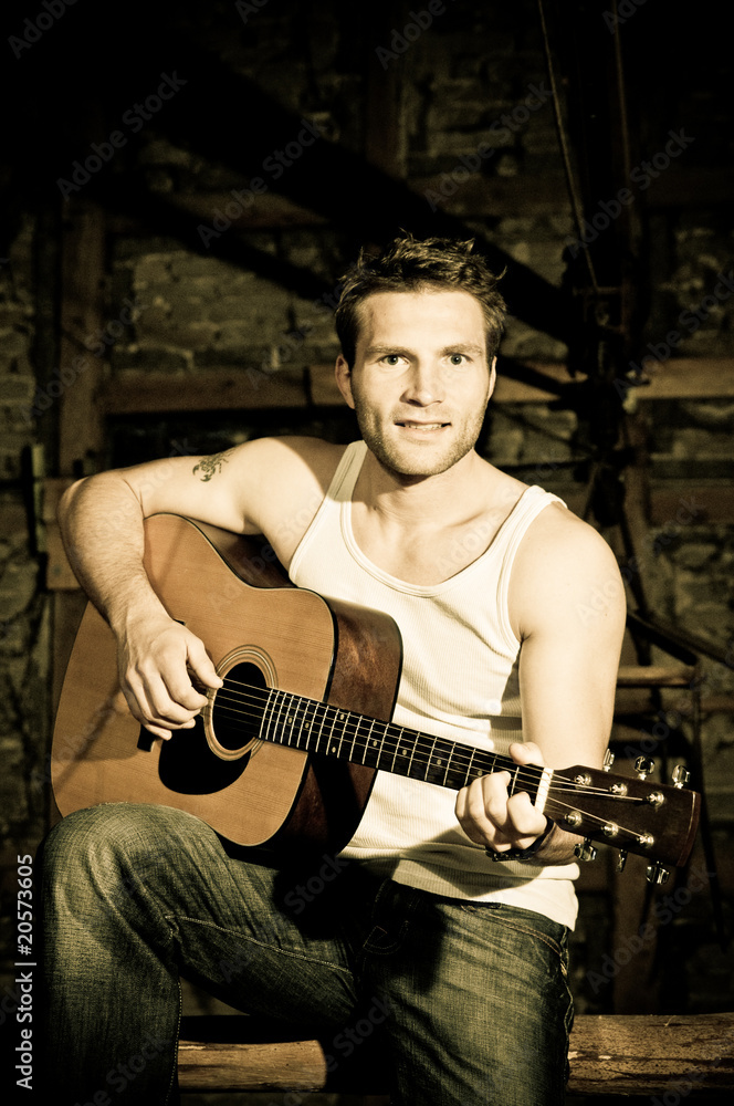 Obraz premium Man is playing a guitar