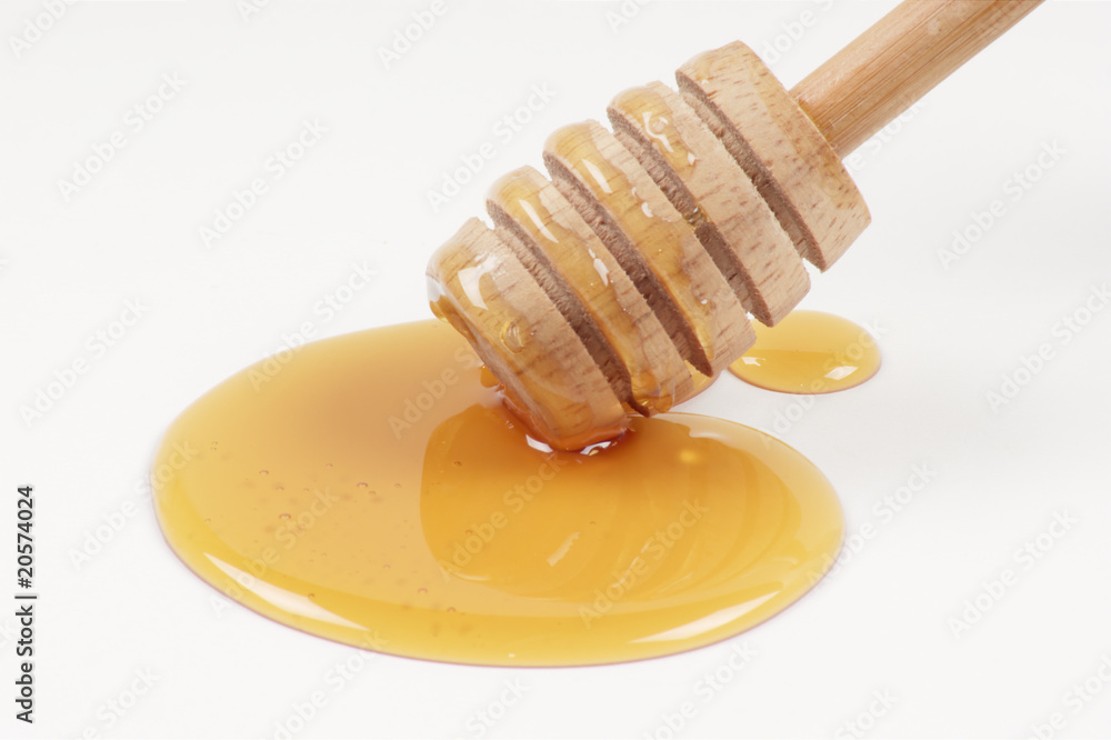 a honeyspoon and some sweet organic honey a honeyspoon and some sweet organic honey