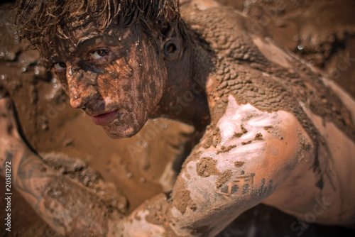young guy full with mud