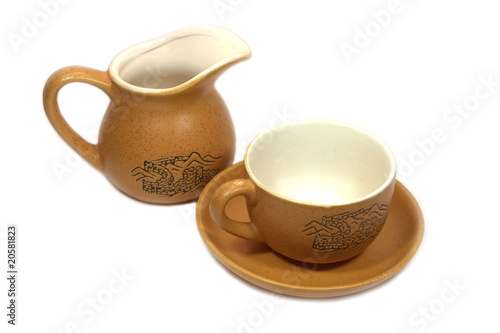Chinese tea cup with saucer and brown milk can isolated on white