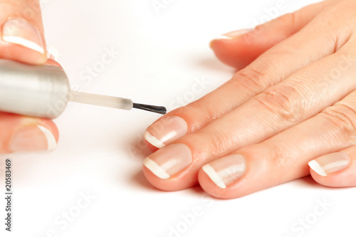 Manicurist applying natural looking nail polish