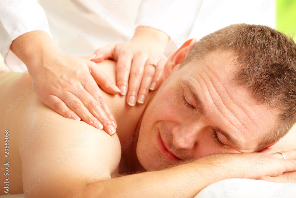 Male enjoying massage treatment Male enjoying massage treatment