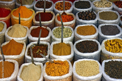 many colorful spice in small bags and spoons
