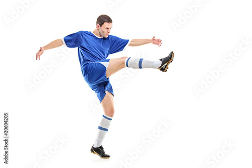 A soccer player shooting isolated on white background