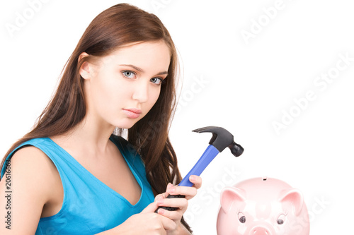 teenage girl with piggy bank and hammer