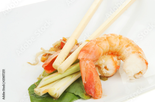 Closeup of prawns with chopsticks