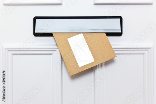 Brown envelope in a front door letterbox