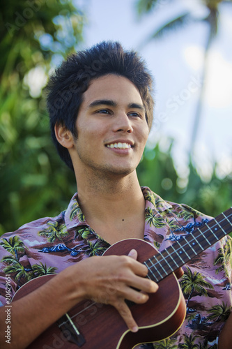 portrait of a pacific island man playing a ukulele in hawaii