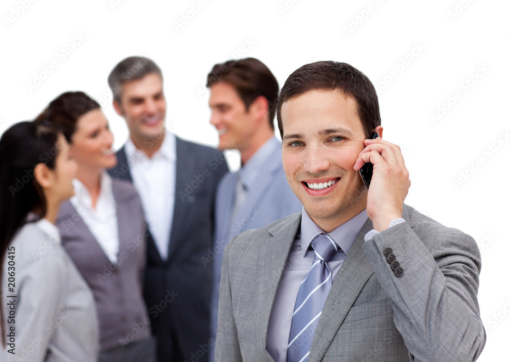 Young manager on phone standig in front of his team Young manager on phone standig in front of his team