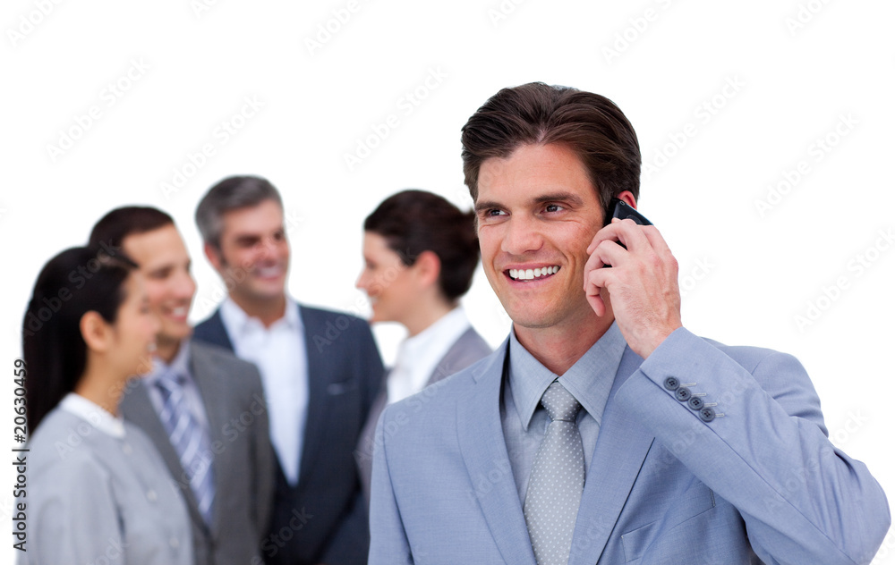 Cheerful manager on phone standig in front of his team Cheerful manager on phone standig in front of his team