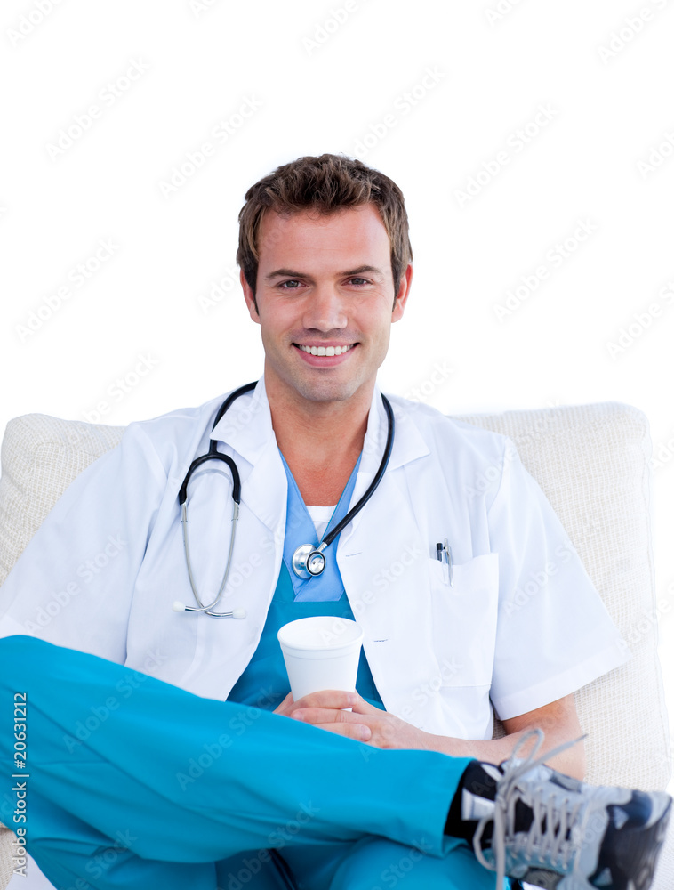 Charming male doctor drinking coffee in the staff room Charming male doctor drinking coffee in the staff room