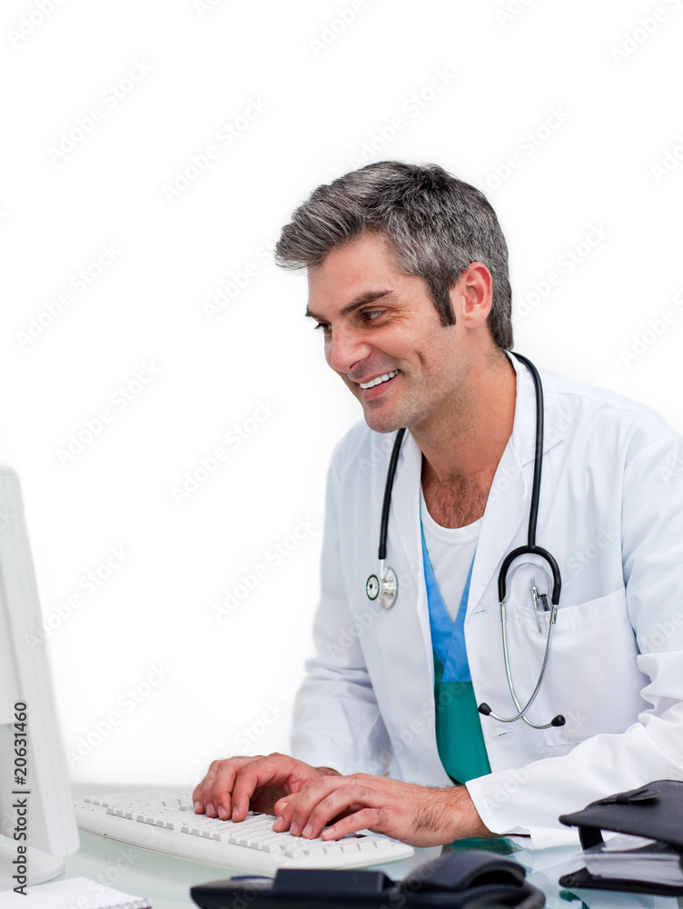 Smiling male doctor working at a computer Smiling male doctor working at a computer