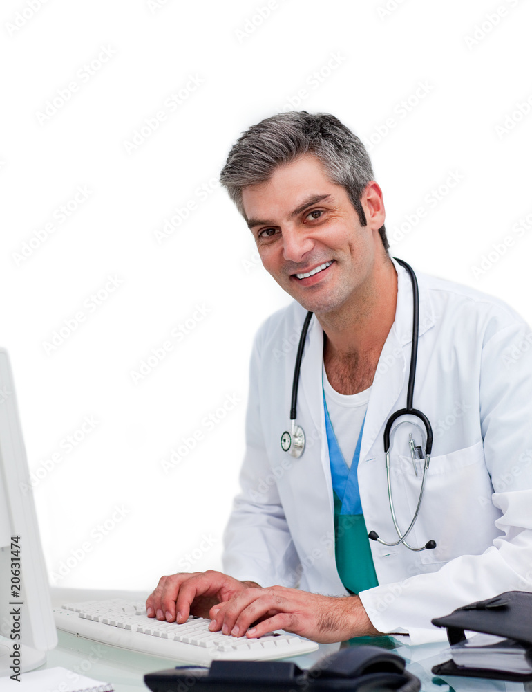 Mature male doctor working at a computer Mature male doctor working at a computer