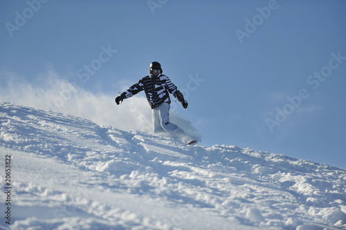 freestyle snowboarder jump and ride